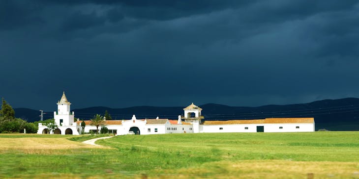 Vista de una hacienda con un cielo nublado de fondo.