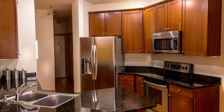 A kitchen with appliances in need of repair.