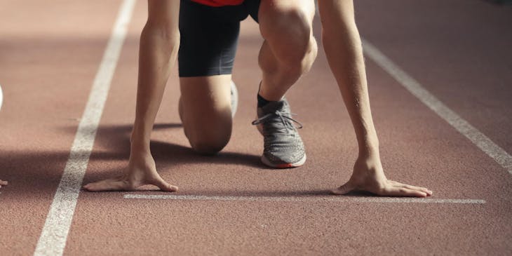 Un athlète prêt à compétir sur une piste d'athlétisme.