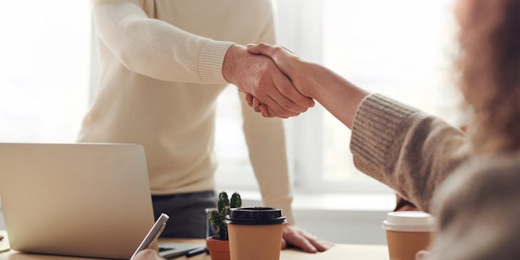 Two individuals shaking hands.