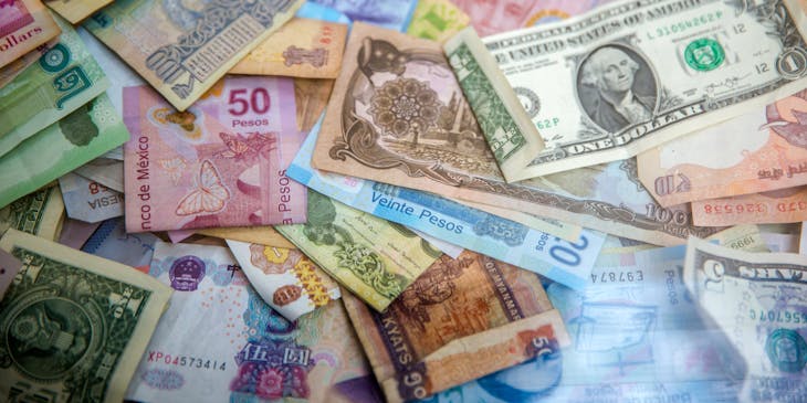 Currency exchange banknotes strewn across a table.