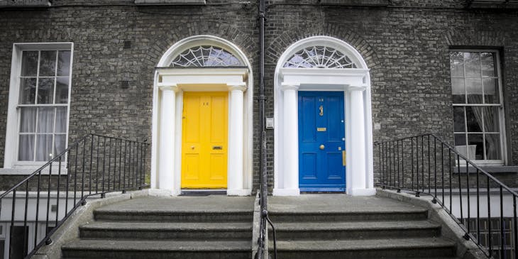 Blue and yellow doors in front of building.