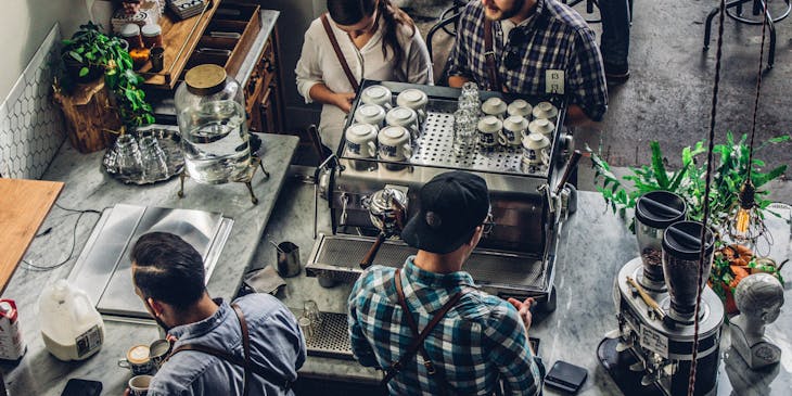 people ordering at a coffee shop with espresso machine