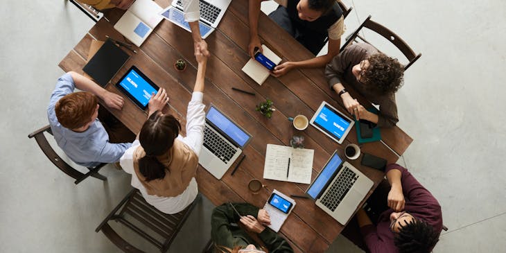 a group of people working on laptops