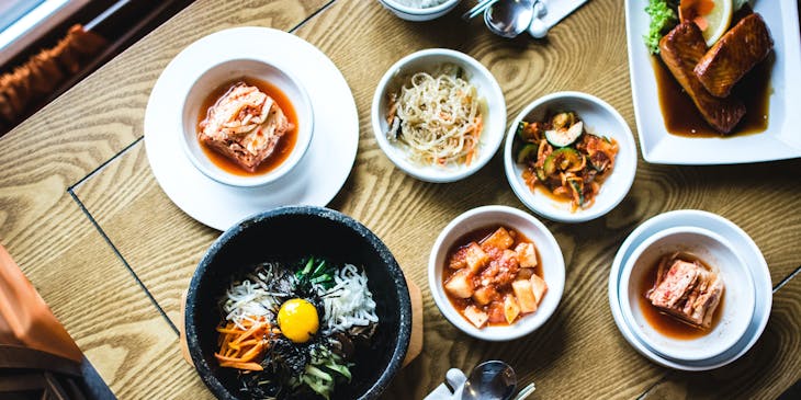 Variety of Korean dishes on a wooden table.