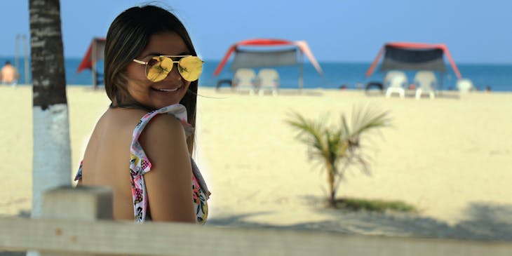 Una mujer sonriendo en una playa en un negocio de ocio.