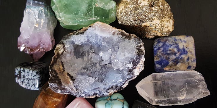 Various gemstones and minerals arranged on a black surface.