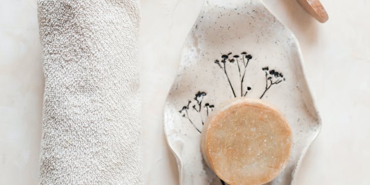 A selection of natural products, including salt, soap, and a brush.