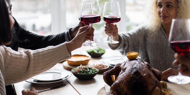 Una familia comiendo y brindando con vino en una enoteca.