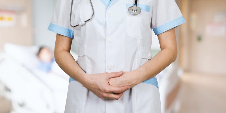 A woman standing in a nursing business.