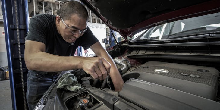 Mechanic checking oil for oil change