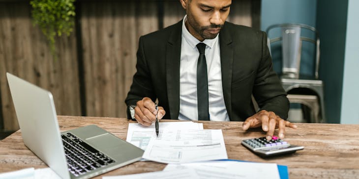 A payroll business employee doing calculations.