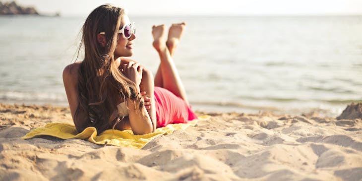 Woman with spray tan on beach.