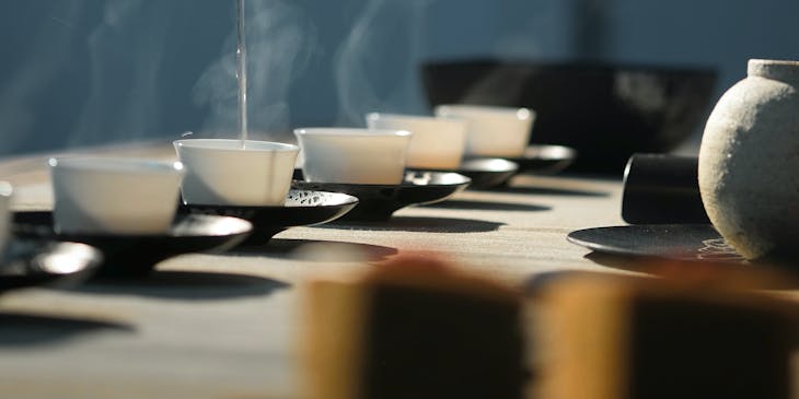 A person pouring tea in a tearoom.