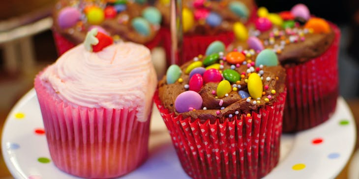 Assortment of colorful cupcakes for sale by a treat business.