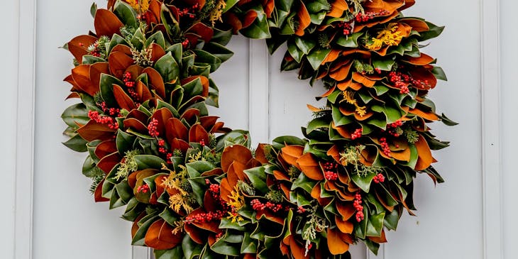 An autumn wreath hanging on a white door.