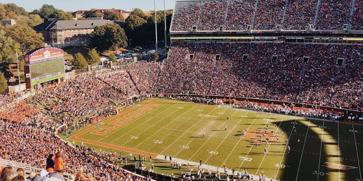 Football stadium with an ongoing game during the day